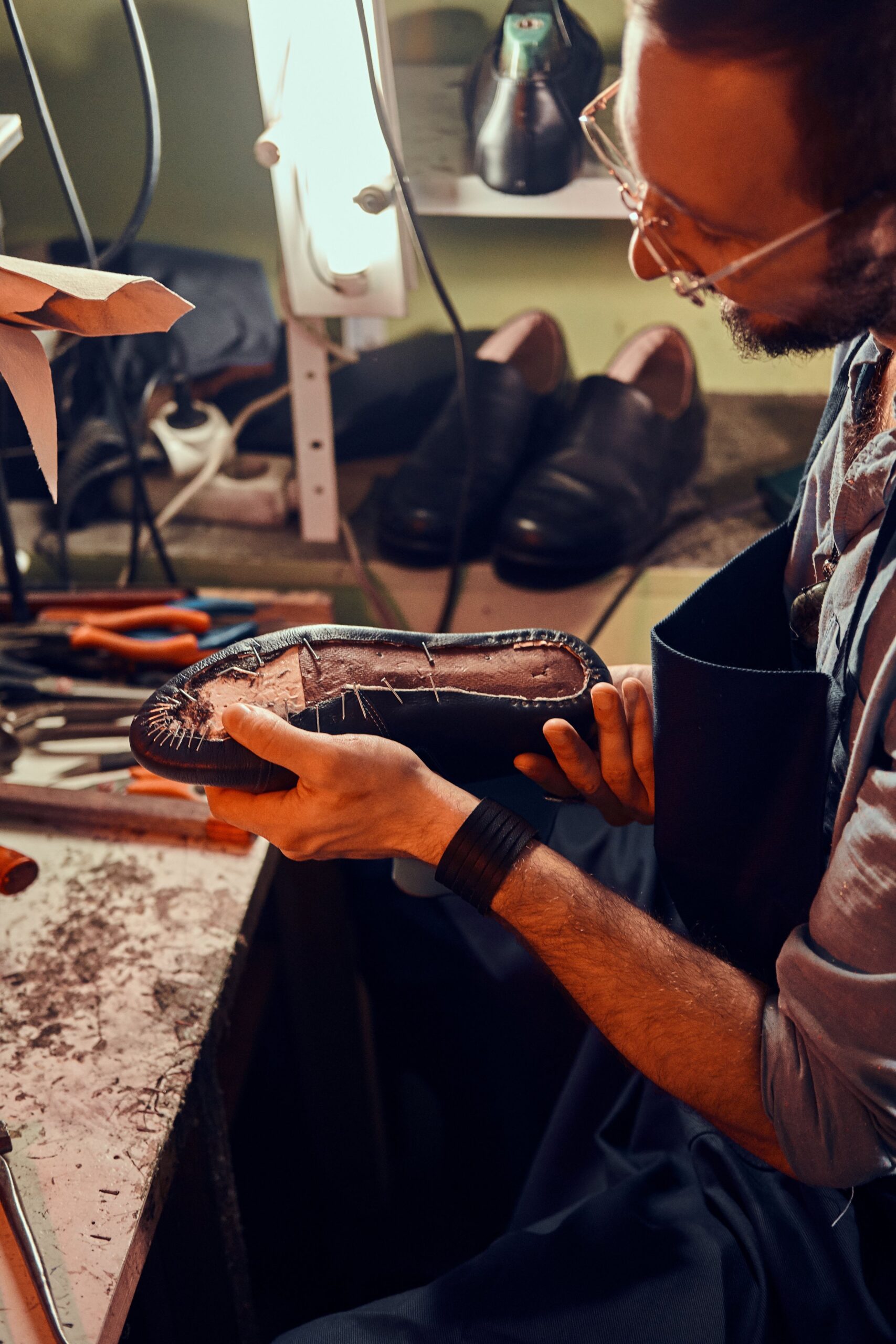 Cobbler is repairing shoes for customers